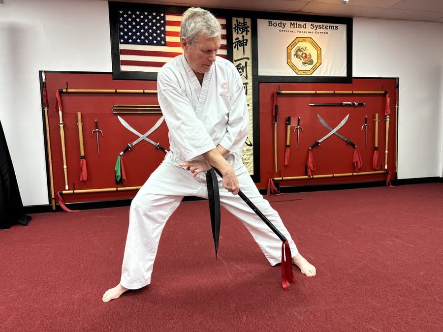 Senior student training with a chain whip