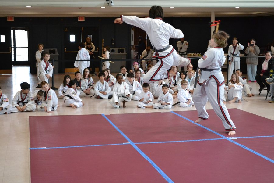 Kids sparring demo with an audience watching